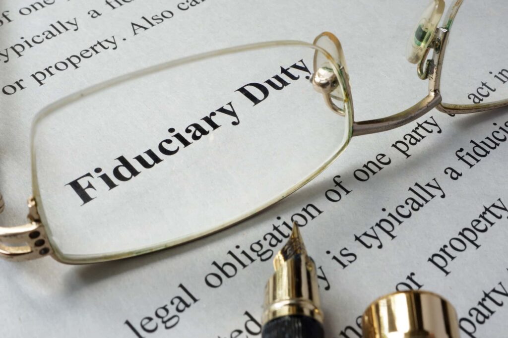 glasses on top of a piece of paper reading " Fiduciary"